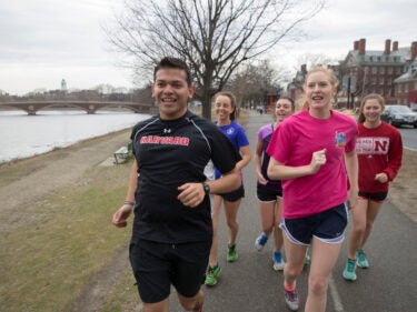 A group of five students running together, training for a marathon