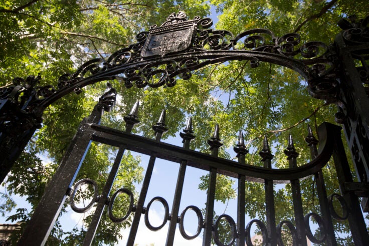 One of the gates of Harvard yard with trees behind it